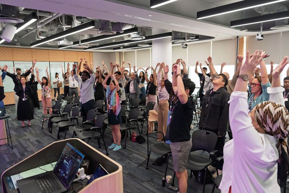 The whole room on its feet with arms in the air during an Energy Booster