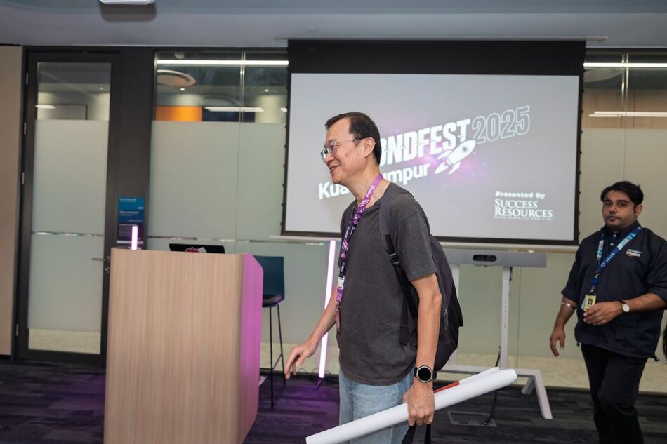 Speaker standing in front of the BeyondFest 2025 title screen