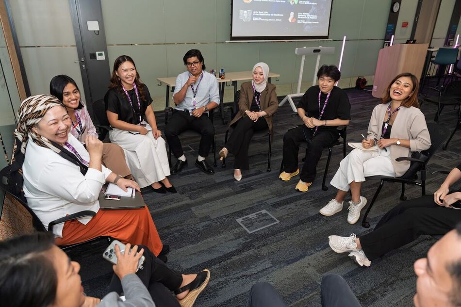 Attendees in a seated circle during an Unconference breakout